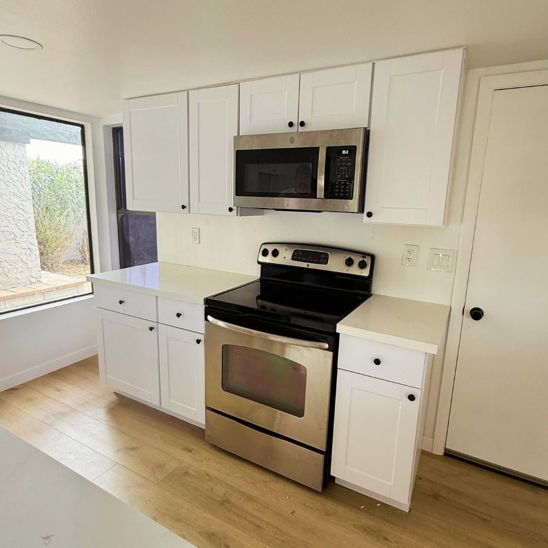 Freshly renovated white kitchen with stainless appliances